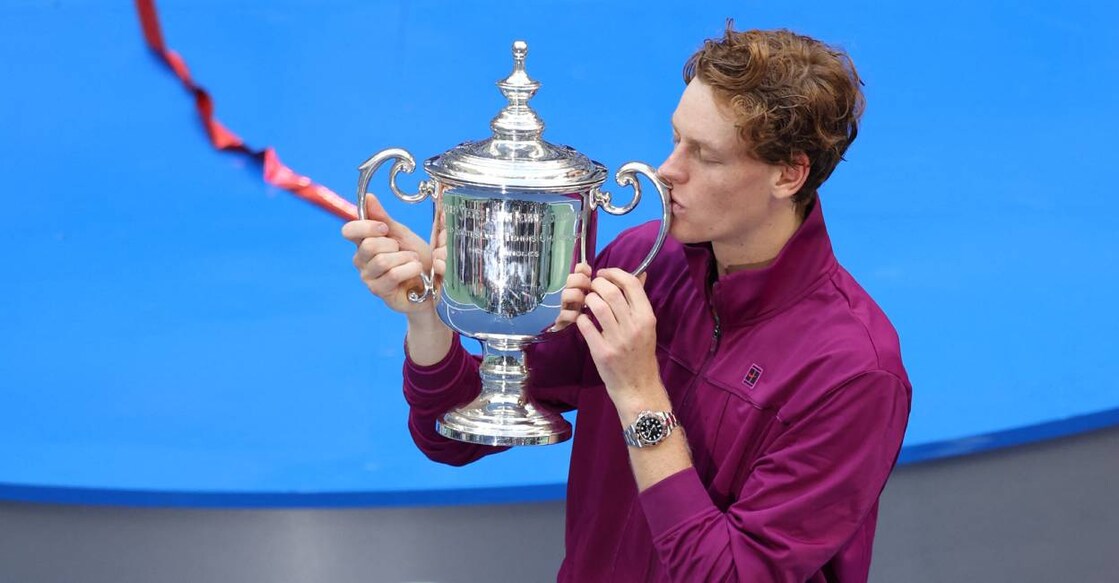 Italy's Jannik Sinner kisses the trophy after winning his men's final match against USA's Taylor Fritz on day fourteen of the US Open tennis tournament. Photo: AFP/ Charly Triballeau