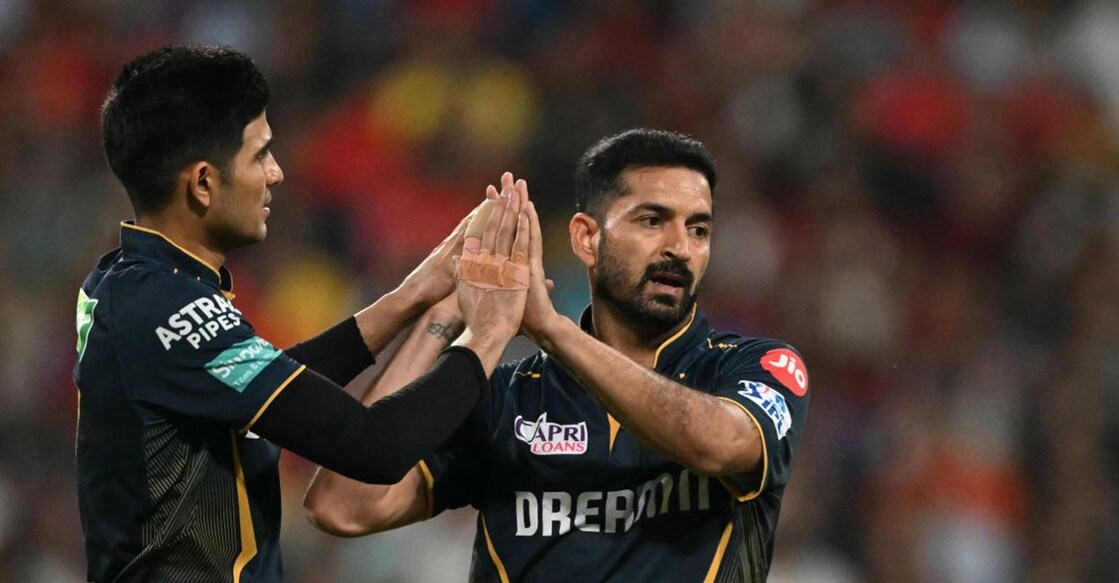 Mohit Sharma, right, celebrates with Gujarat Titans captain Shubman Gill after picking up a wicket against Punjab Kings in IPL 2024. File photo: AFP/Sajjad Hussain