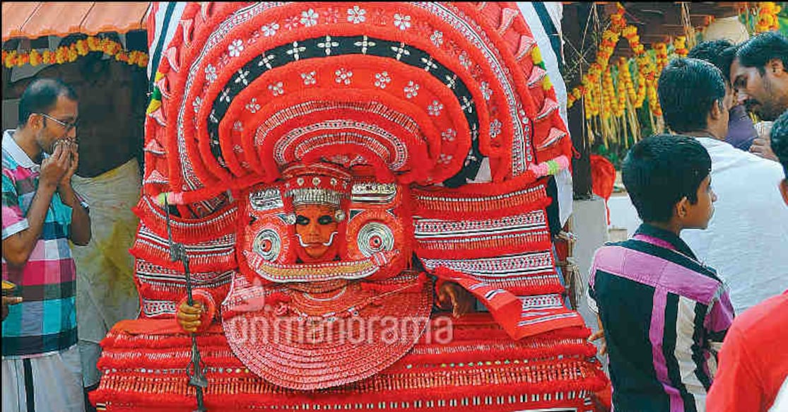 Krishnan, a construction worker, performs wearing a 20-foot-high headdress. Photo: THE WEEK