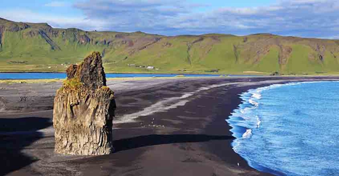  On an ocean beach with volcanic sand 