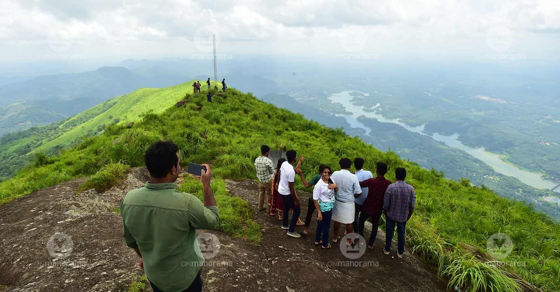 Students of the Mahatma Gandhi University's Master in Travel and Tourism Management during an excursion to Ilaveezhapoonchira. Idukki's Malankara Reservoir can also be seen. Photo: Rijo Joseph