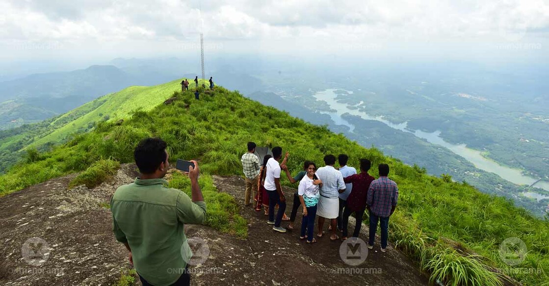 Students of the Mahatma Gandhi University's Master in Travel and Tourism Management during an excursion to Ilaveezhapoonchira. Idukki's Malankara Reservoir can also be seen. Photo: Rijo Joseph