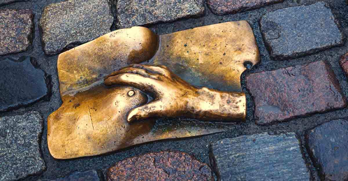 bronze-breast AMSTERDAM, THE NETHERLANDS - APRIL 2, 2018: Bronze relief to the female breast in the street cobblestones in the Red Light District, by artist Rob Hodgson. Modern tourist landmarks of Amsterdam.