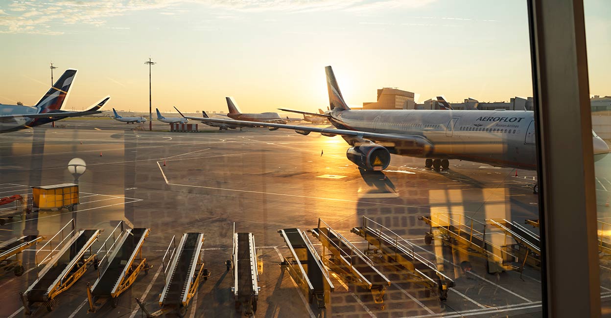 Sheremetyevo airport Modern aircraft,behind the glass facade of the window in the waiting room of the Sheremetyevo airport, Moscow. Photo: iStock/Sergey Dolgikh