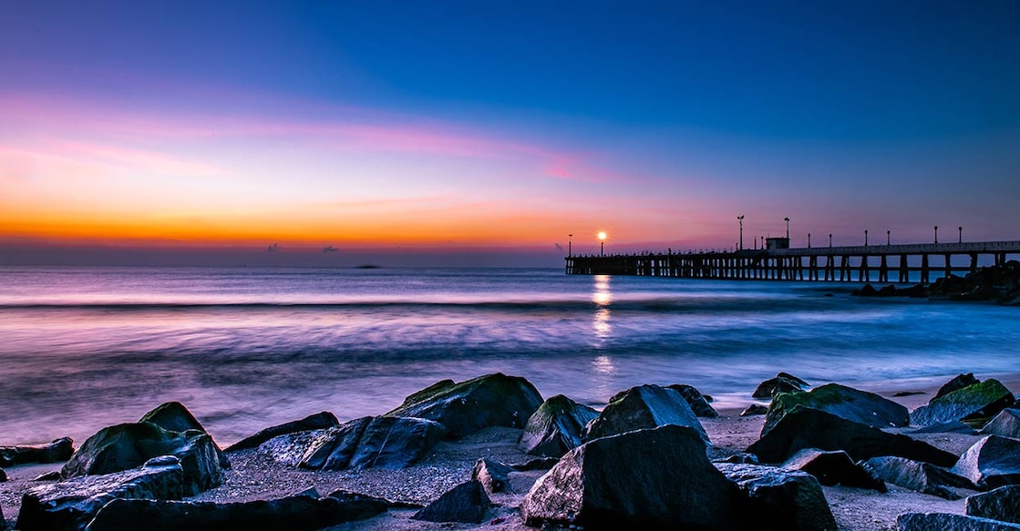 Blue Hour before the sunrise along the pier and the lamp in the pier looks like the star on the rocky shore in Pondicherry. Photo: Shutterstock/Subash Lingam