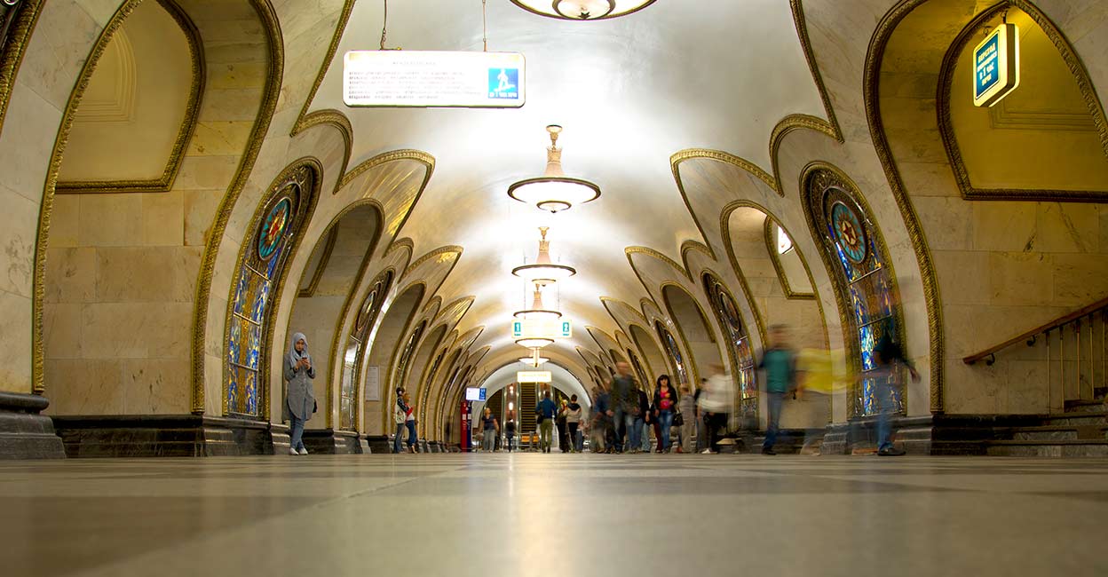 moscow-metro-station-1 Commuters in Novoslobodskaya Moscow metro station. Stain glass panels form the central theme for this station opened in 1952. Photo: iStock/Lisa-Blue