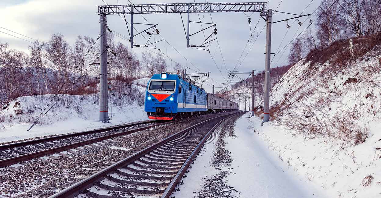 A passenger train moves along Lake Baikal along the Trans-Siberian route. Photo: Shuttesrtock/Locomotive74