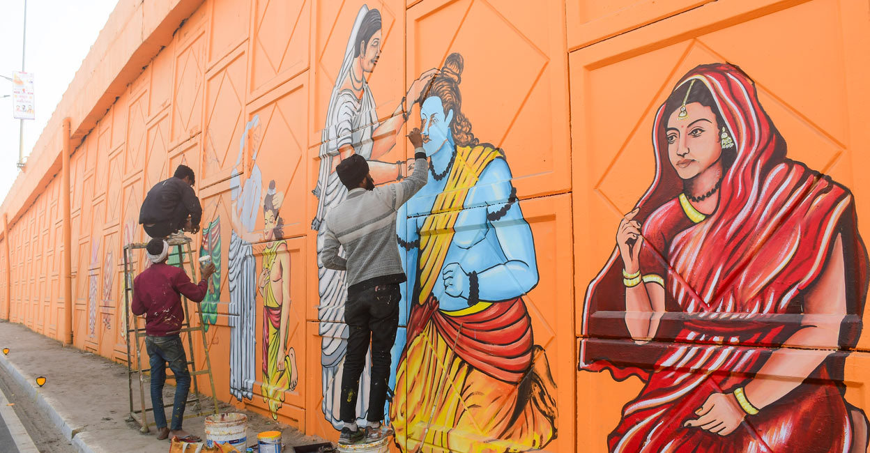 Artists make graffiti depicting Lord Ram and Goddess Sita on the wall of an overbridge ahead of the Jan. 22 consecration of the Ram Mandir, in Ayodhya. Photo: PTI