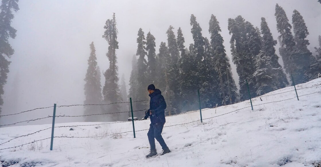 A tourist amid light snowfall at ski resort Gulmarg, in Baramulla district on January 28, Sunday, 2024. Gulmarg received a fresh snowfall breaking a two-month-long dry spell. Photo: PTI