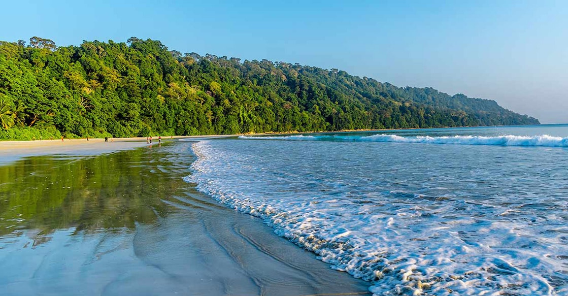 One of the most beautiful beaches in the country, Radhanagar Beach is known for its clear turquoise waters, unspoiled beauty, and ideal swimming conditions, even for non-strong swimmers. Photo:  iStock/Mrinal Pal
