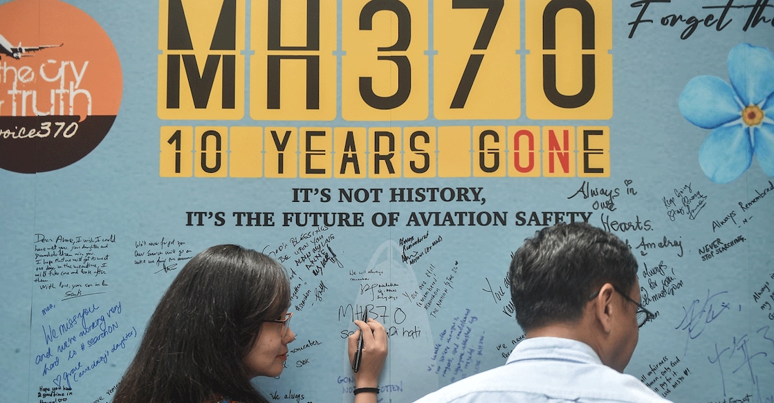 A woman writes a message during an event held by relatives of the passengers and supporters to mark the 10th year since the Malaysia Airlines flight MH370 carrying 239 people disappeared from radar screens on March 8, 2014. Photo: AFP
