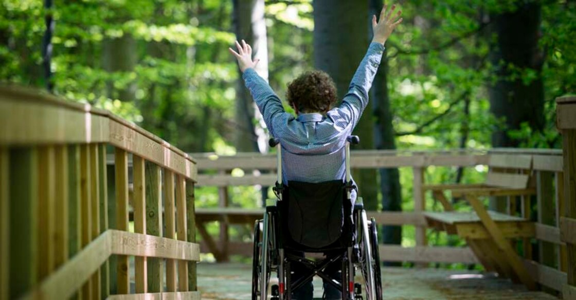 "Eleven year old boy,wheelchair bound, very happy to be rolling down a purpose built wheelchair access point at Moen's Klint in Denmark."