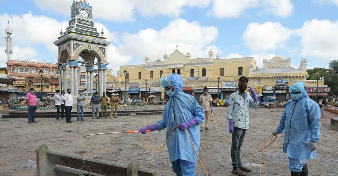 Mysuru: Fire personnel engaged in conducting sanitisation drive across public places in Mysuru amid rising cases of COVID-19, on June 25, 2020. (Photo: IANS)