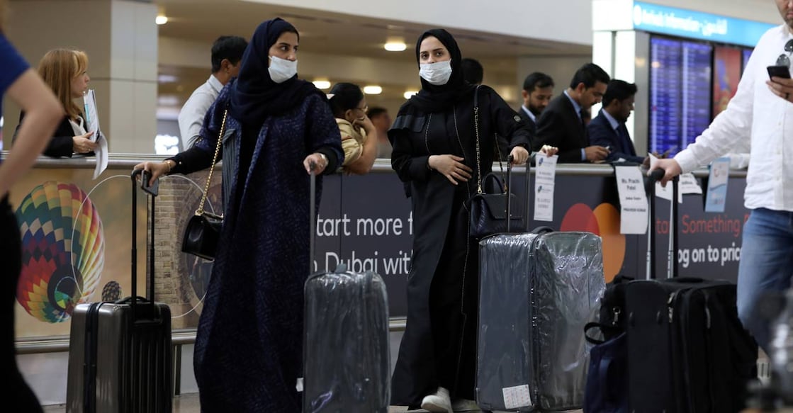 CHINA-HEALTH-EMIRATES Travellers wear masks as they arrive at the Dubai International Airport. File/REUTERS/Christopher Pike