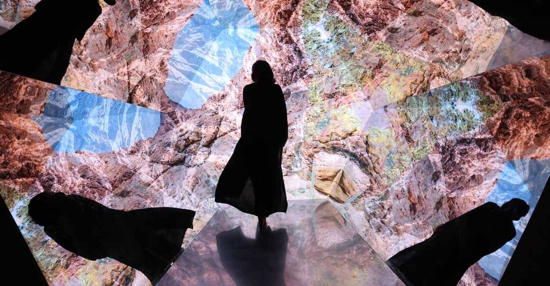 A woman looks at a video installation at a pavillion at the Expo 2020, in the Gulf Emirateof Dubai, on December 1, 2021.
Photo: Giuseppe CACACE / AFP