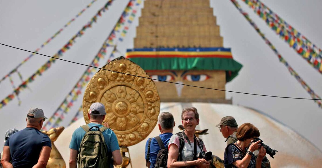 Foreign tourists take photographs of Boudhanath Stupa at a monastery in Kathmandu, Nepal, April 24, 2022. Picture taken April 24, 2022. Photo: REUTERS/Monika Deupala