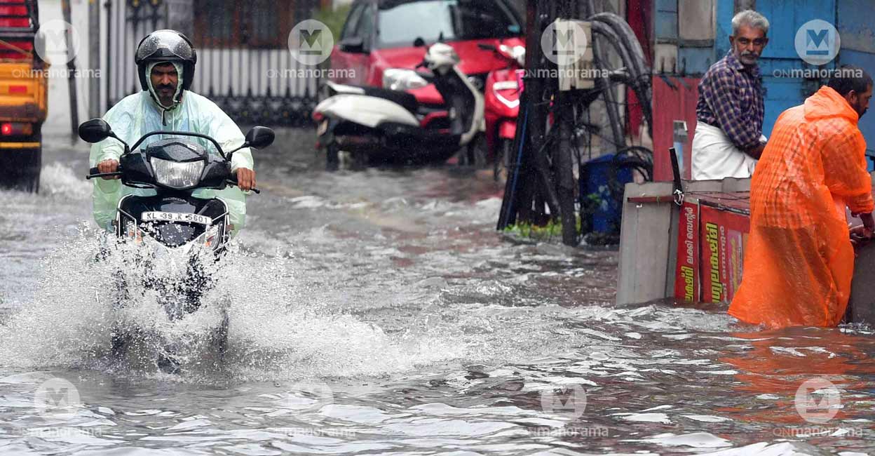 A scooter rider wading through the floodwater in Kochi's Jew Street. Photo: Josekutty Panackal