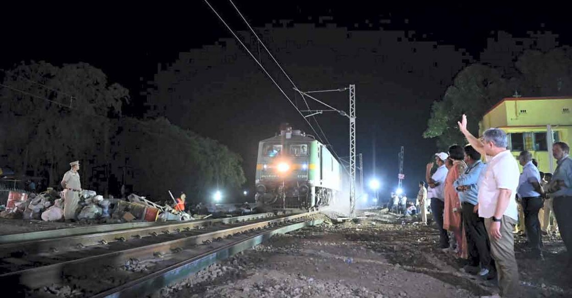 Railways Minister Ashwini Vaishnaw waves at a goods train as train services resume on the section where the accident happened on Friday, near Bahanaga Bazar railway station in Balasore district, Sunday night, June 4, 2023. Photo: Swapan Mahapatra/PTI
