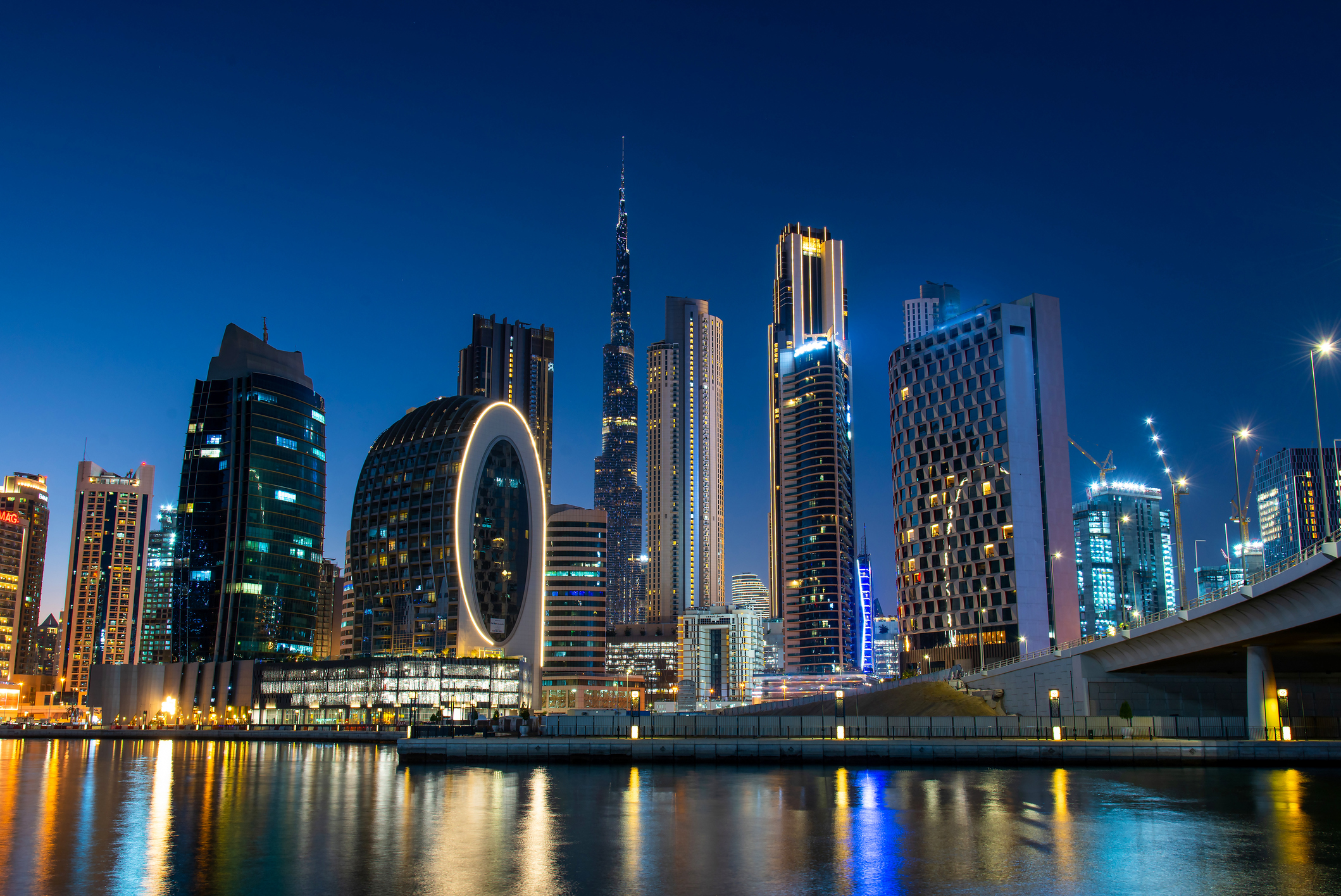 1309800161 Dubai modern architecture landmark skyline view from the Marasi marina in city Business bay downtown area in the United Arab Emirates at blue hour at night