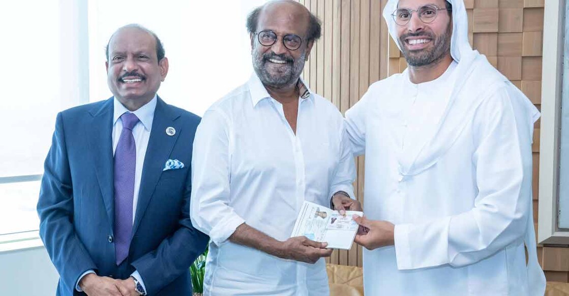 Rajinikanth (middle) receives the Golden Visa from UAE's DTC Chairman Mohamed Khalifa Al Mubarak. M A Yusuff Ali on his left. Photo: Special Arrangement