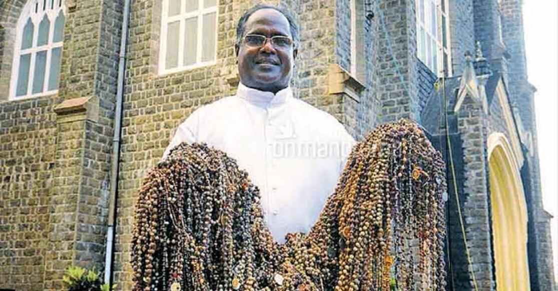 The priest holding the sacred 'mala' removed by the Ayyappa devotees at Arthunkal Basilica. Photo: Onmanorama